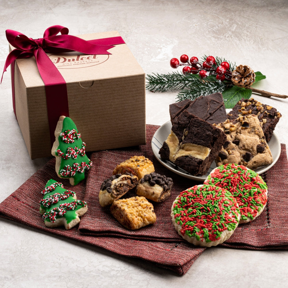 Dulcet Christmas gift box with decorated Christmas tree cookies, red and green sprinkle cookies, assorted chocolate brownies and gourmet rugelach.