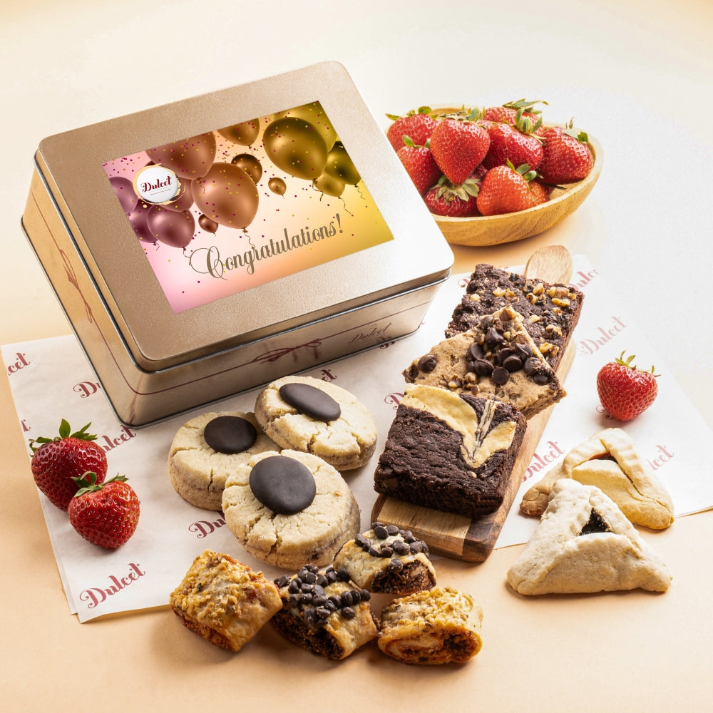 Dulcet congratulations gift tin with festive balloon design, assorted gourmet cookies, chocolate brownies, blondies, hamantaschen and rugelach.