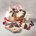 Dulcet gold get well gift tin filled with chocolate and vanilla iced black and white cookies, featuring a pink floral Get Well Soon lid and burgundy ribbon.