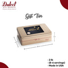 Dulcet gold holiday gift tin with a black and gold Happy Holidays lid, measuring 8 x 6 x 3 inches, weighing 2 lb, and made in the USA.