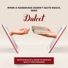 Dulcet gifting banner illustrating a gold gift tin being passed between two people through digital screens, highlighting thoughtful long-distance gifting and protective packaging for freshness.