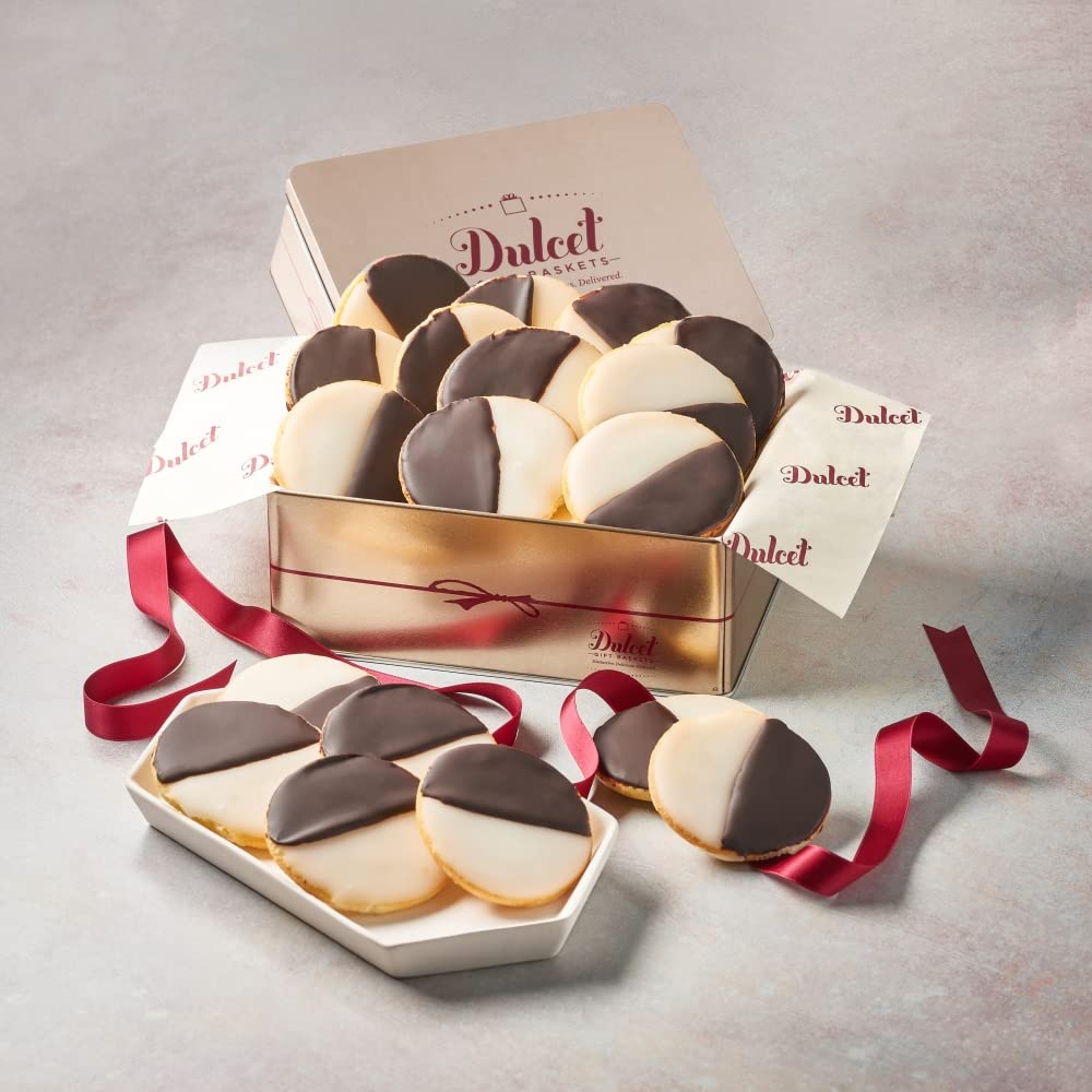 Black and white cookies in a gold gift tin with a Dulcet branded box and red ribbon.