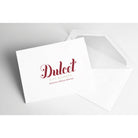 Dulcet Gift Baskets logo printed on a white greeting card beside an open white envelope.