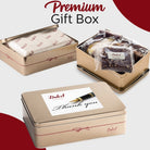 Dulcet thank-you gold gift tin shown open with individually wrapped bakery treats and closed with a fountain pen design on the lid.