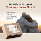 Dulcet Thinking of You gift tin beside a couple embracing at sunset, promoting gifts for bereavement, comfort or a hug.
